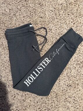 Hollister size medium gray drawstring sweatpants with “Hollister” down one leg